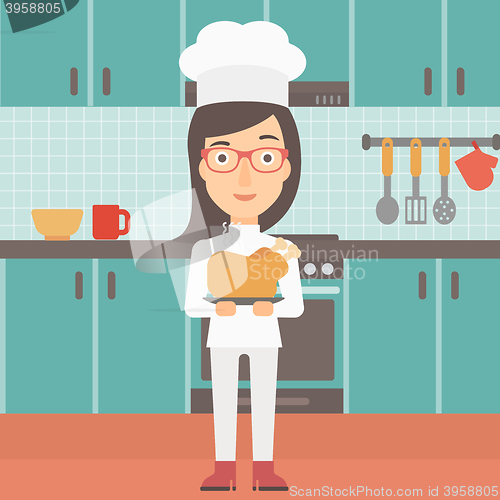 Image of Woman holding roasted chicken.