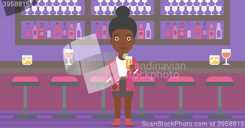 Image of Woman holding glass of juice.