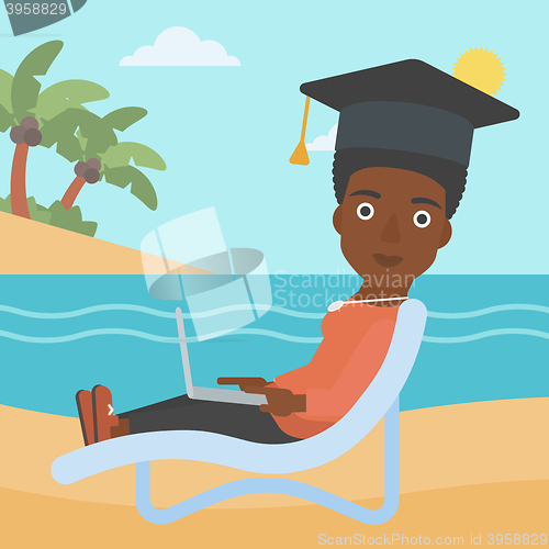 Image of Graduate lying on chaise lounge with laptop.