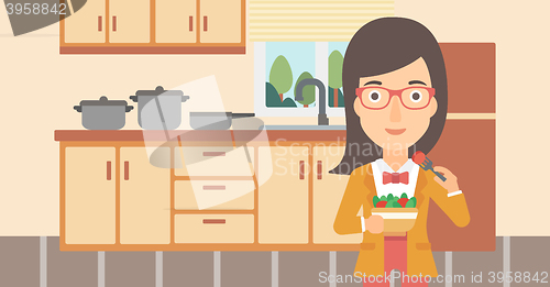 Image of Woman eating salad.