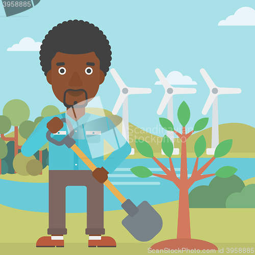 Image of Man plants tree.