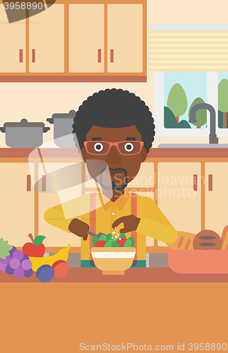 Image of Man cooking vegetable salad.