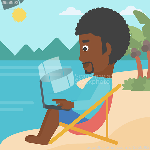 Image of Businessman sitting in chaise lounge with laptop.