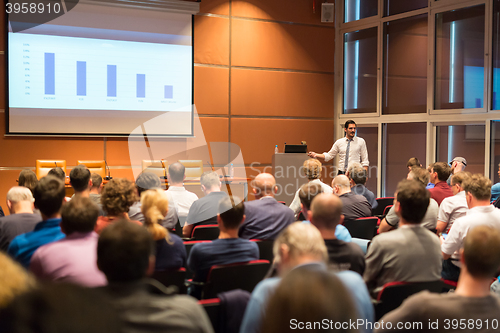 Image of Business speaker giving a talk in conference hall.