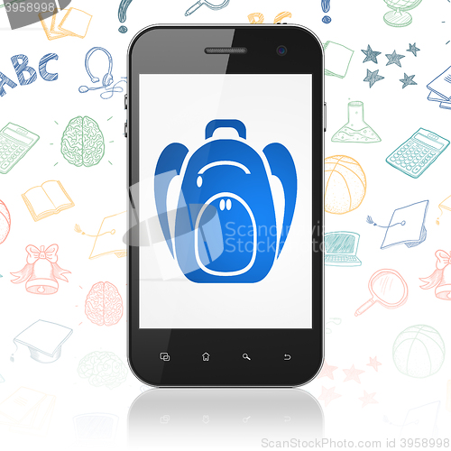Image of Learning concept: Smartphone with Backpack on display