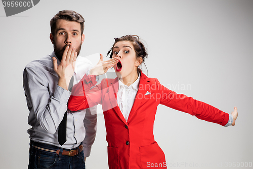 Image of The yawning business man and woman