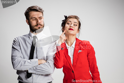 Image of The business man and woman communicating on a gray background