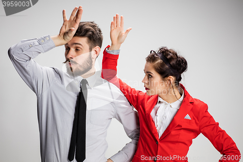 Image of The business man and woman communicating on a gray background