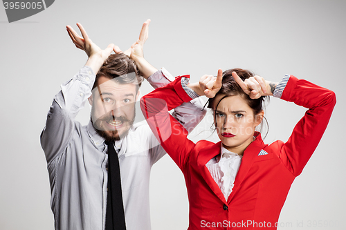 Image of The business man and woman communicating on a gray background