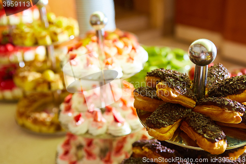 Image of Dessert table for party. akes and sweetness. Shallow dof