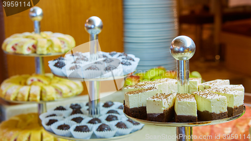 Image of Dessert table for party. akes and sweetness. Shallow dof