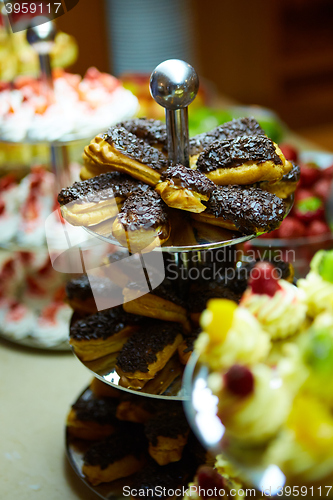 Image of Dessert table for party. akes and sweetness. Shallow dof