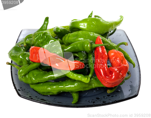 Image of Green and red chili peppers on glass plate