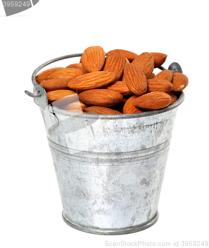 Image of Old tin bucket with almonds
