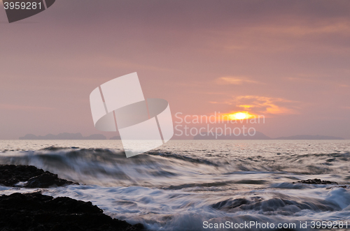 Image of The sunset over the sea with waves