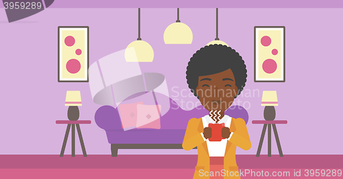 Image of Woman sitting with cup of coffee.