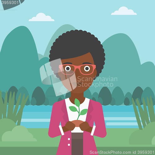 Image of Woman holding plant.