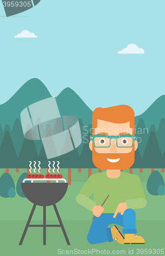 Image of Man preparing barbecue.