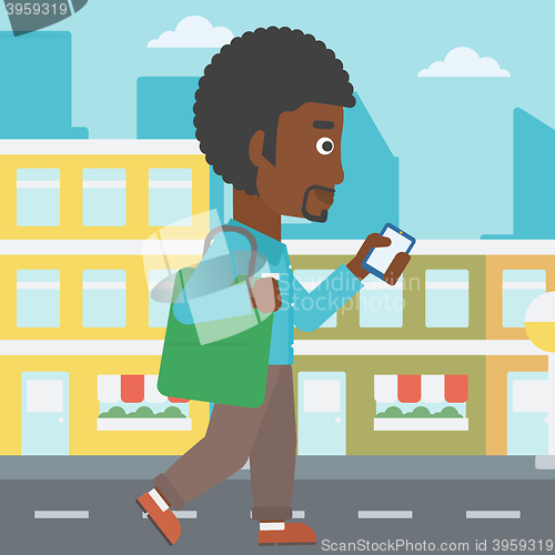 Image of Man walking with smartphone.