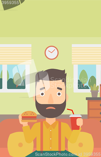 Image of Man eating hamburger. 