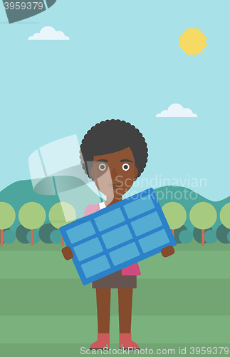 Image of Woman holding solar panel.