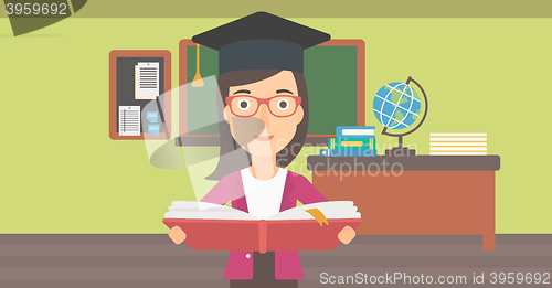 Image of Woman in graduation cap holding book.