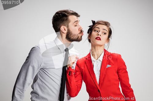 Image of The business man and woman communicating on a gray background