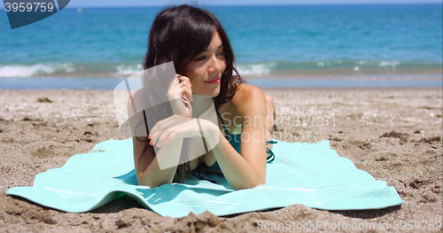 Image of Pretty woman sunbathing on a tropical beach