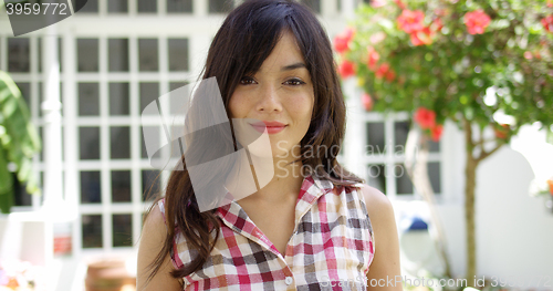 Image of Pretty young woman in a tropical garden