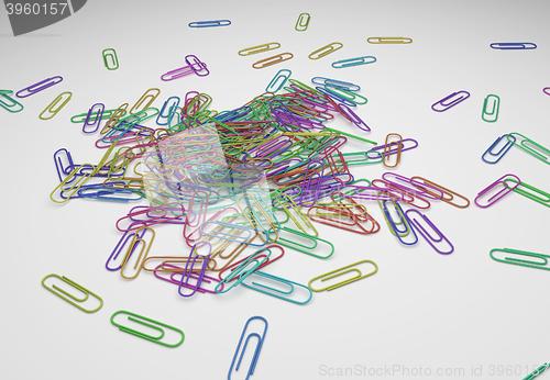 Image of many color paperclips on desk