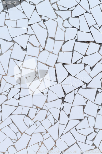 Image of White broken tiles wall