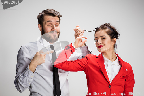 Image of The business man and woman communicating on a gray background