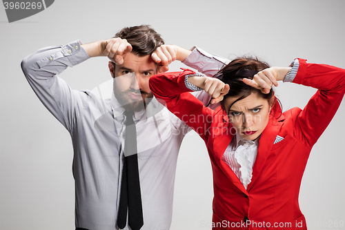 Image of The business man and woman communicating on a gray background