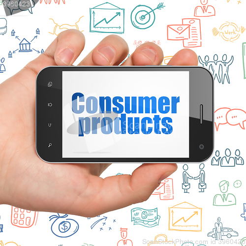 Image of Business concept: Hand Holding Smartphone with Consumer Products on display