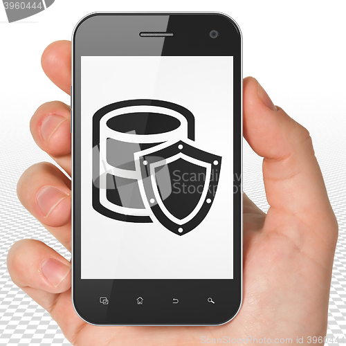 Image of Programming concept: Hand Holding Smartphone with Database With Shield on display