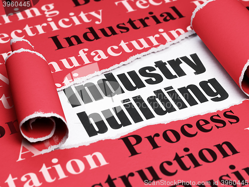 Image of Manufacuring concept: black text Industry Building under the piece of  torn paper