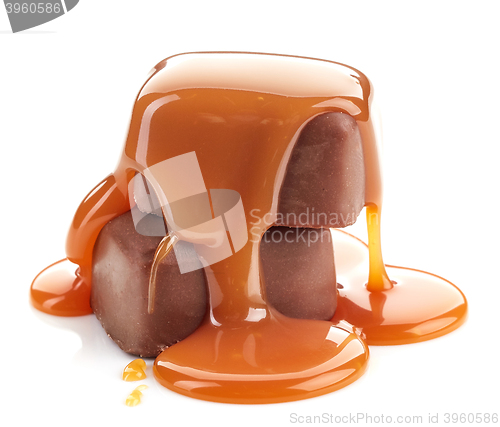 Image of caramel sauce pouring on chocolate candies