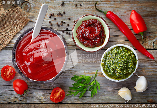 Image of various sauces on wooden table