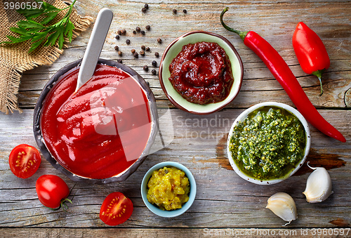 Image of various sauces on wooden table