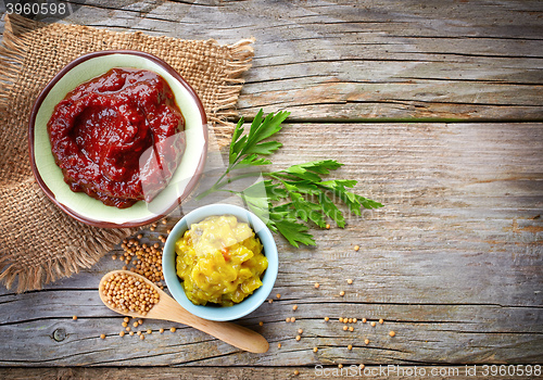 Image of various sauces on wooden table