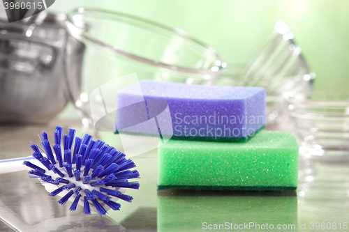 Image of household cleaning sponges and brush