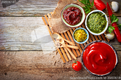 Image of various sauces on wooden table