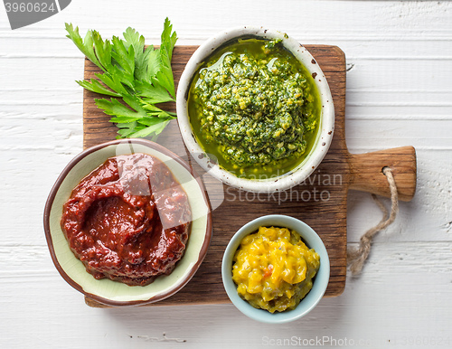 Image of various sauces on wooden cutting board