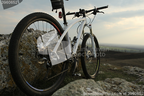 Image of Bicycle stands on a rock