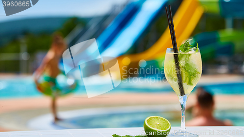 Image of Close up Cocktail margaritas with lime near the swimming pool