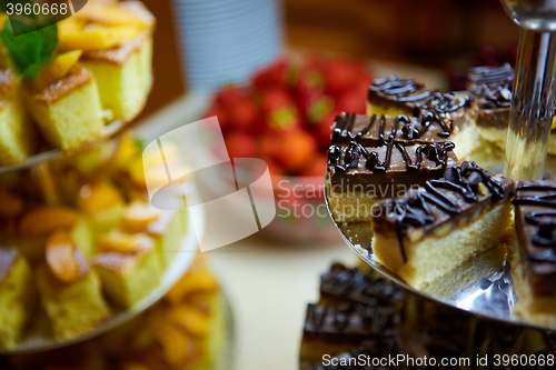 Image of Dessert table for party. akes and sweetness. Shallow dof