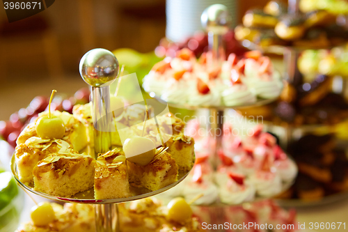 Image of Dessert table for party. akes and sweetness. Shallow dof