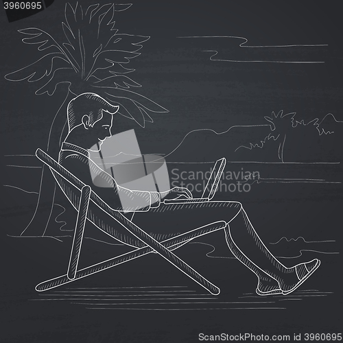 Image of Businessman sitting in chaise lounge with laptop.