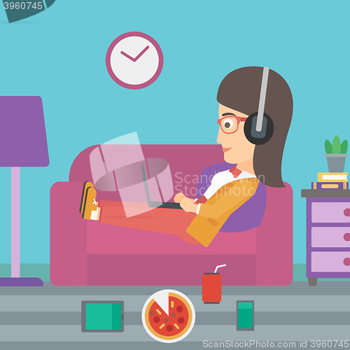 Image of Woman lying on sofa with many gadgets.