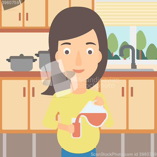 Image of Pregnant woman pouring juice.